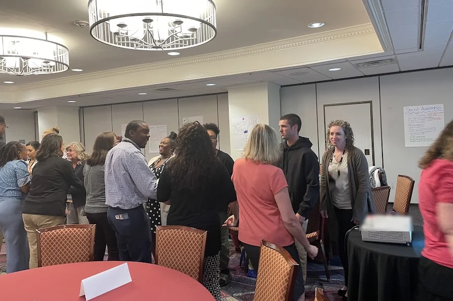 Educators meeting and talking during a professional learning workshop