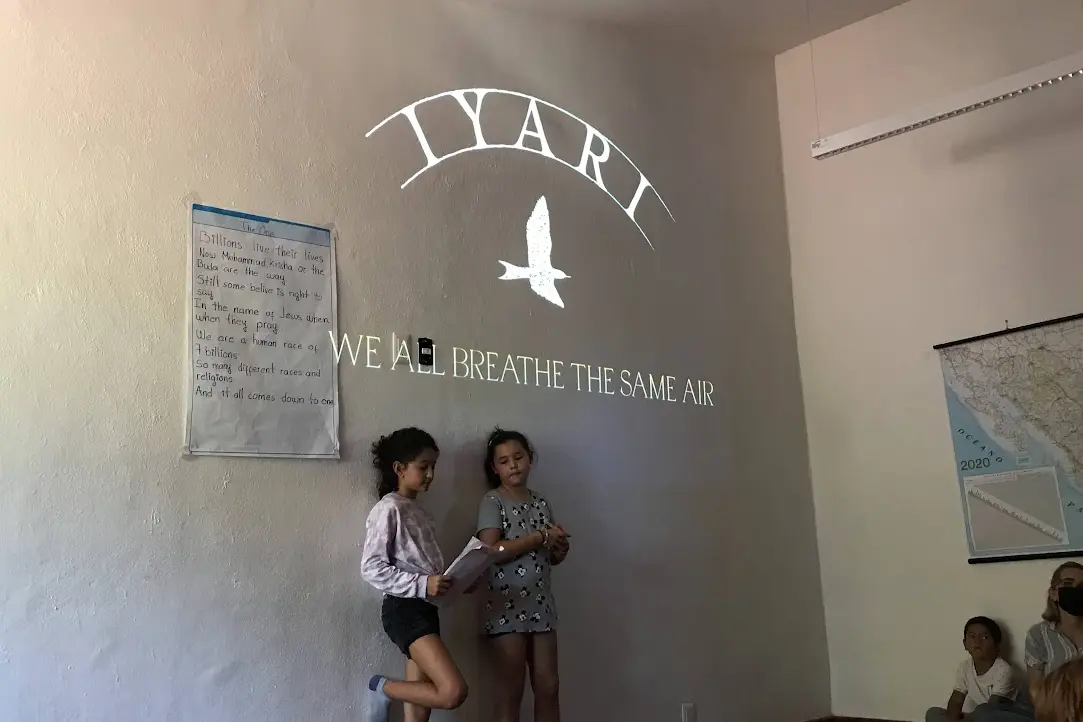 Iyari students present a poem to their community